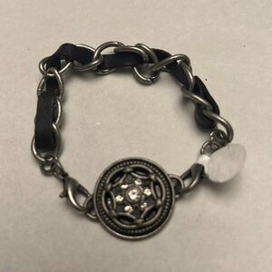 Handcrafted aged silver toned bracelet with leather detail